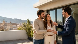 Pareja recibiendo las llaves de su primera vivienda en Alcoi con las montañas al fondo